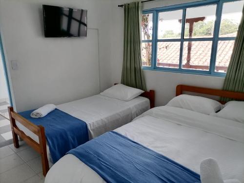 Una cama o camas en una habitación de Laureles de la Villa
