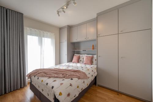 een slaapkamer met een bed en een grote witte kast bij Meerzicht-Laguna in Knokke-Heist