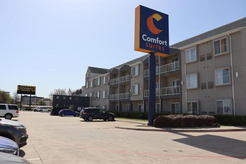 a sign for a comfort suites in a parking lot at Comfort Suites DFW Airport in Irving