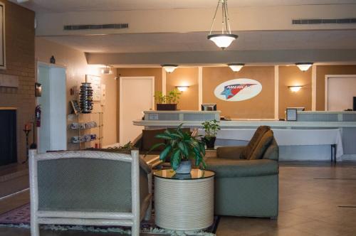 a lobby of a store with chairs and a counter at America's Inn Houston/Stafford /Sugarland in Houston