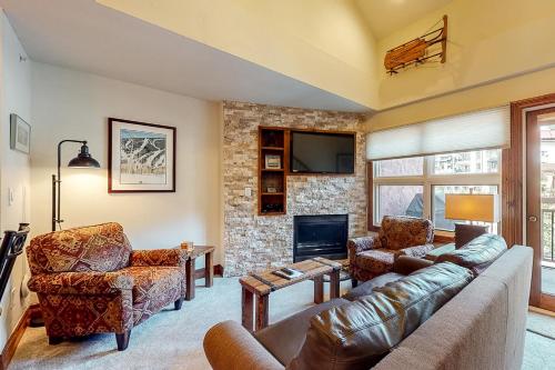 a living room with a couch and chairs and a fireplace at Lion Square Lodge South 556 in Vail
