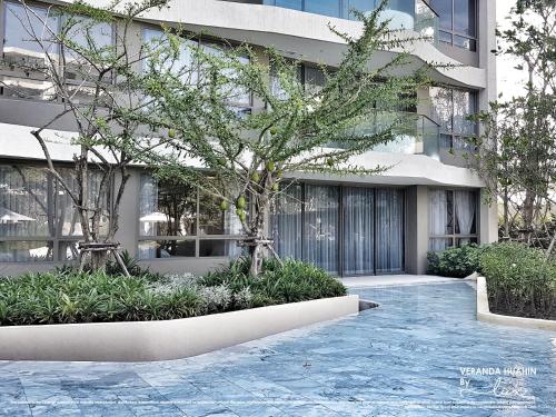 a building with a sidewalk in front of a building at VERANDA HUAHIN BY LUX in Hua Hin