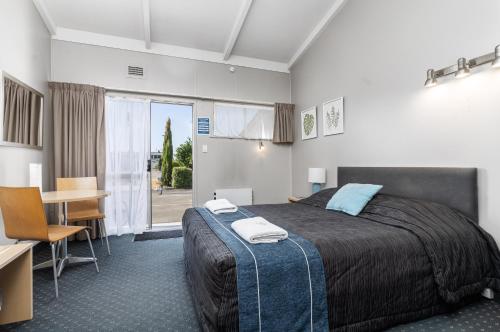Un pat sau paturi într-o cameră la Amble Inn Motel