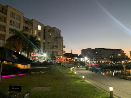 a city street at night with buildings and lights at CONDOMINIOS de la BAHIA - Apart Departamento - BAHIA GRANDE - NORDELTA in Tigre