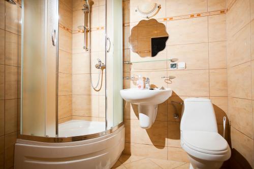 a bathroom with a toilet and a sink and a shower at Pensjonat Bogdanka in Trzęsacz