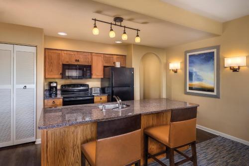a kitchen with a large island with a sink at The Legacy Golf Resort in Phoenix