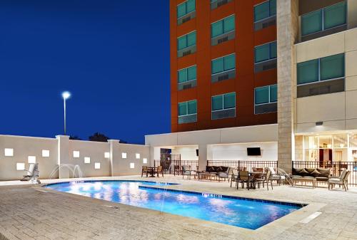 a swimming pool in front of a building at Holiday Inn Express & Suites Memorial – CityCentre, an IHG Hotel in Houston