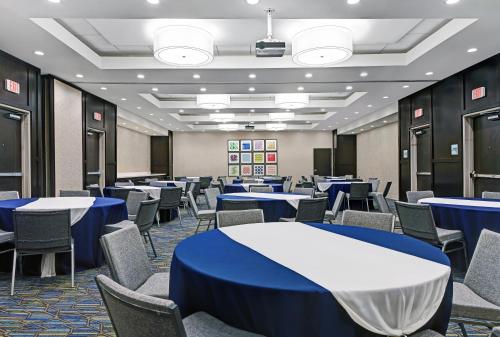 a conference room with blue tables and chairs at Holiday Inn Express & Suites Memorial – CityCentre by IHG in Houston