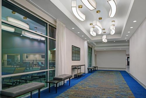 a waiting room with benches and a whiteboard at Holiday Inn Express & Suites Memorial – CityCentre by IHG in Houston