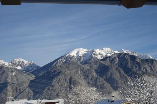 a snow covered mountain with a snow covered mountain at Ferienwohnungen Simon - Hauserhof in Oberperfuss