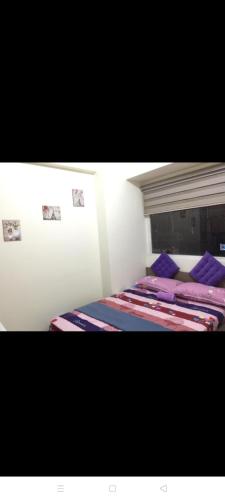 two beds in a room with pictures on the wall at Urban Deca Tower Graceysplace Unit unit 3113 Mandaluyong in Manila