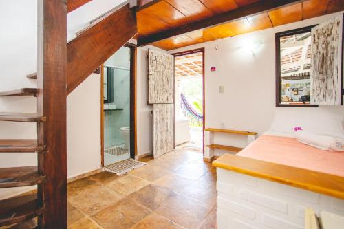 a room with a staircase leading to a bathroom at Pousada da Renata in Jericoacoara