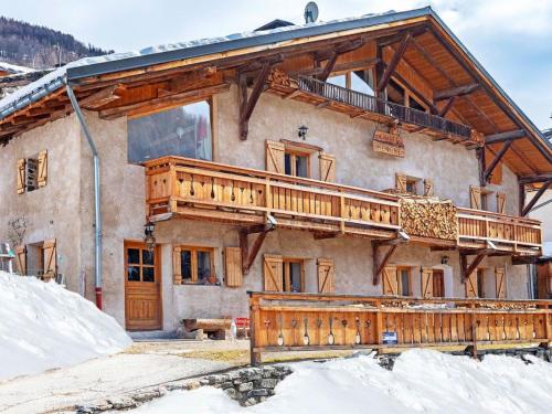 a house with a deck on the side of it at Pretty Chalet with Sauna Skiing Nearby in Peisey-Nancroix