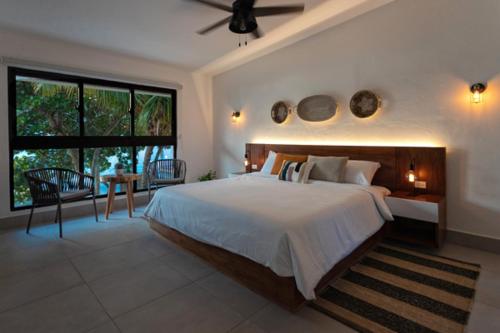 a bedroom with a large bed and a large window at Bay Shore 76 in Palmar de Ocoa
