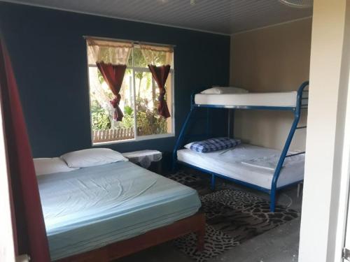 a room with two bunk beds and a window at Sophie House in Moyogalpa