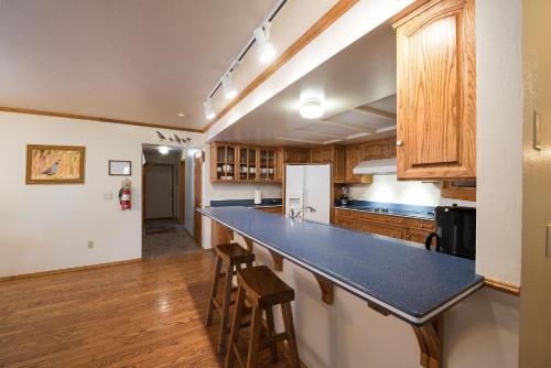 a kitchen with a large counter top and wooden cabinets at Quail Crossing Lodge in Yosemite West