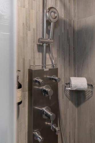 a bathroom with a shower with four faucets at Hotel YAM LAGOM in Kaohsiung