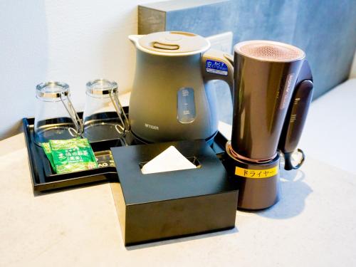 a counter with a blender and a napkin at Hotel Area One Ise Inter in Ise