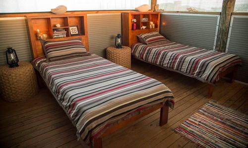 two beds in a room with at Wilderness Island in Exmouth
