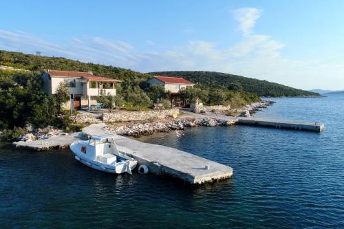 a boat is docked at a dock in the water at House Sea Gull in Tkon