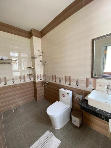 a bathroom with a toilet and a sink at Marguerite Villa in Da Lat