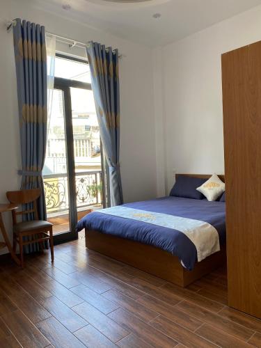 a bedroom with a bed and a balcony at Marguerite Villa in Da Lat