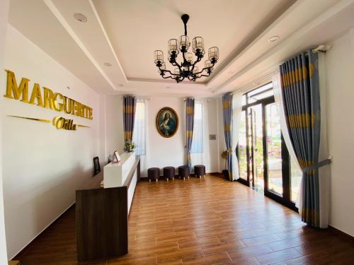 a large hallway with a chandelier and a room with a hard wood floor at Marguerite Villa in Da Lat
