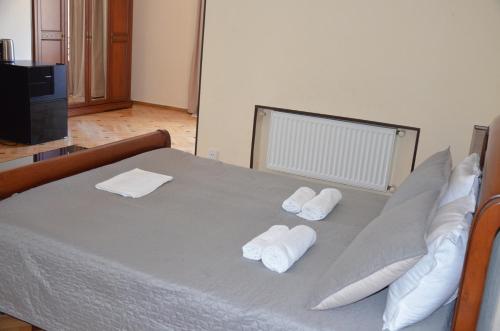 a bedroom with a bed with towels on it at Borjomi Sichi in Borjomi