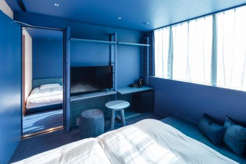 
a bedroom with a bed and a window at toggle hotel suidobashi TOKYO in Tokyo

