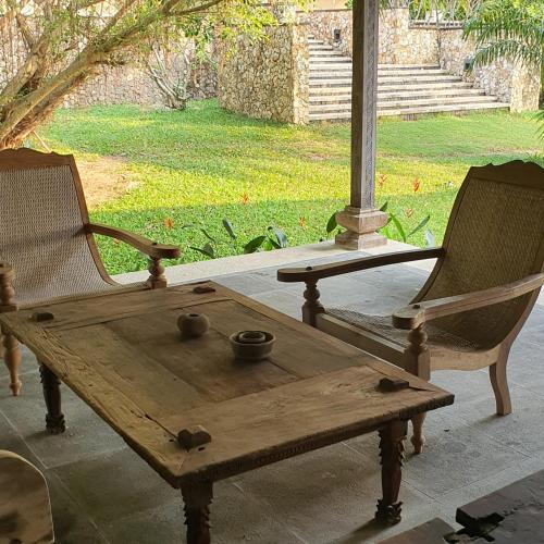 a wooden table and two chairs on a porch at Tropical villa in the Bangsare hills near Pattaya in Bang Sare