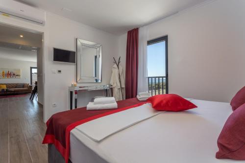 a bedroom with a large bed with red and white sheets at Pleasure Bol in Bol