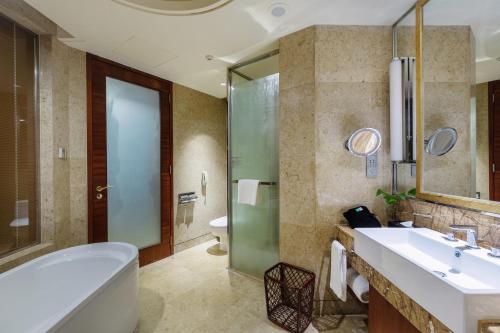 a bathroom with a tub and a sink and a toilet at Holiday Inn Resort Chaohu Hot Spring, an IHG Hotel in Chaohu