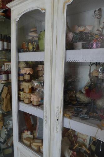 a white cabinet filled with lots of different items at Domaine de la Manse in Villeneuve-de-Berg