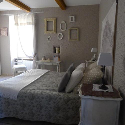 a bedroom with a large bed and a window at Domaine de la Manse in Villeneuve-de-Berg