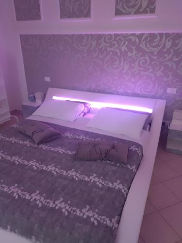 a bedroom with a bed with a light on it at B&B Regina Margherita in LʼAquila