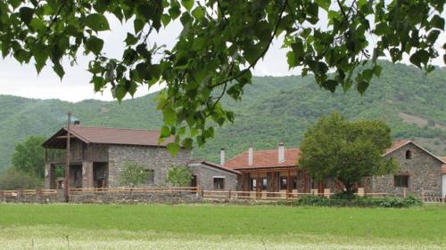 a large stone house in the middle of a field at Ihnilatis in Kerkíni