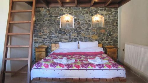 a bedroom with a bed with two candles on it at Ihnilatis in Kerkíni
