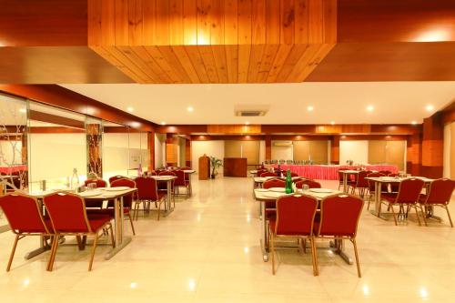 a dining room with tables and chairs in a restaurant at Icon Suites by Bhagini in Bangalore