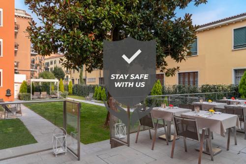a sign that says stay safe with us at a restaurant at Carnival Palace - Venice Collection in Venice