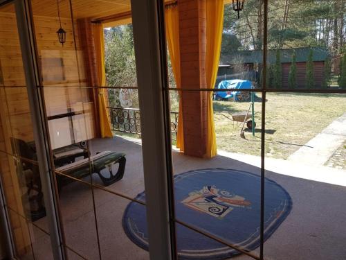 a screened in porch with a frisbee on the floor at Zielony Domek - Tleń Bory Tucholskie in Tleń
