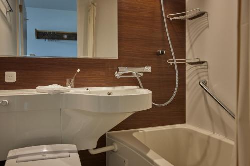a bathroom with a sink and a toilet and a shower at HOTEL tuka miika in Ishigaki Island