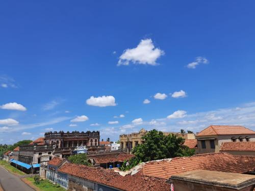 a view of a city with roofs and a blue sky at Chettinadu Court- HERITAGE VIEW in Kānādukāttān