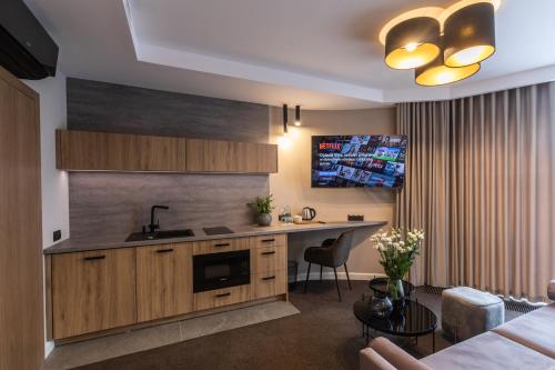 a kitchen with a sink and a counter top at Apartamenty Green Place in Kańczuga