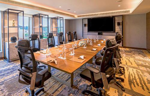 a large conference room with a long table and chairs at Welcomhotel by ITC Hotels, Bhubaneswar in Bhubaneshwar