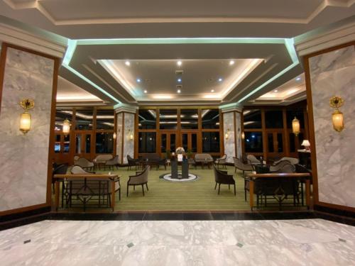 a lobby of a hotel with tables and chairs at Napalai Hotel in Udon Thani