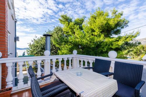 a patio with a table and chairs on a balcony at Apartment & Rooms Villa Katarina in Slano