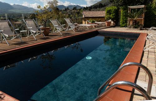 a swimming pool with a pool table and chairs at Casa Rossa in Monreale