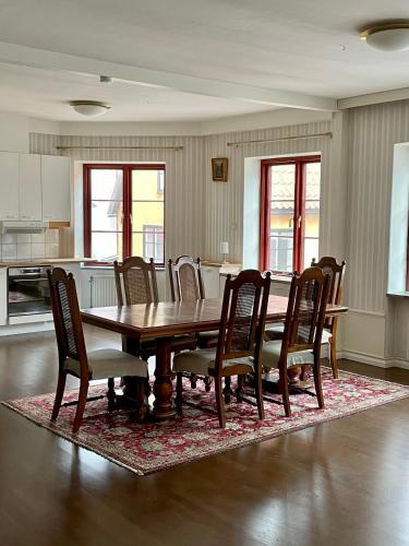 a dining room with a wooden table and chairs at Börsen Annex in Visby