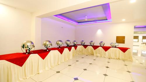 a room with a long table with gold and red decorations at HOTEL SHIV SHAKTI in Bhopal