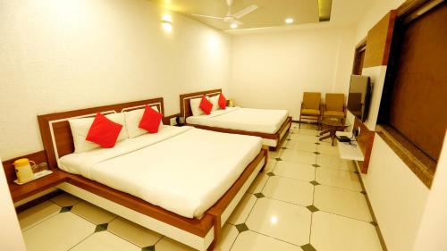 a hotel room with two beds and a tv at HOTEL SHIV SHAKTI in Bhopal